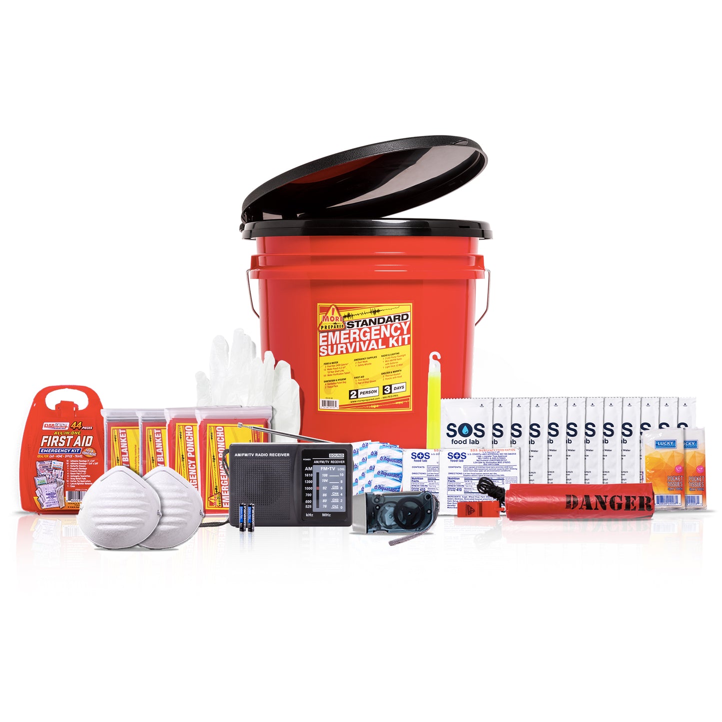 A survival emergency kit set arranged on a white background, featuring a red plastic bucket with a black toilet seat lid, food, water pouches, white masks, a black radio, a whistle, blanket, poncho, and first aid kit.