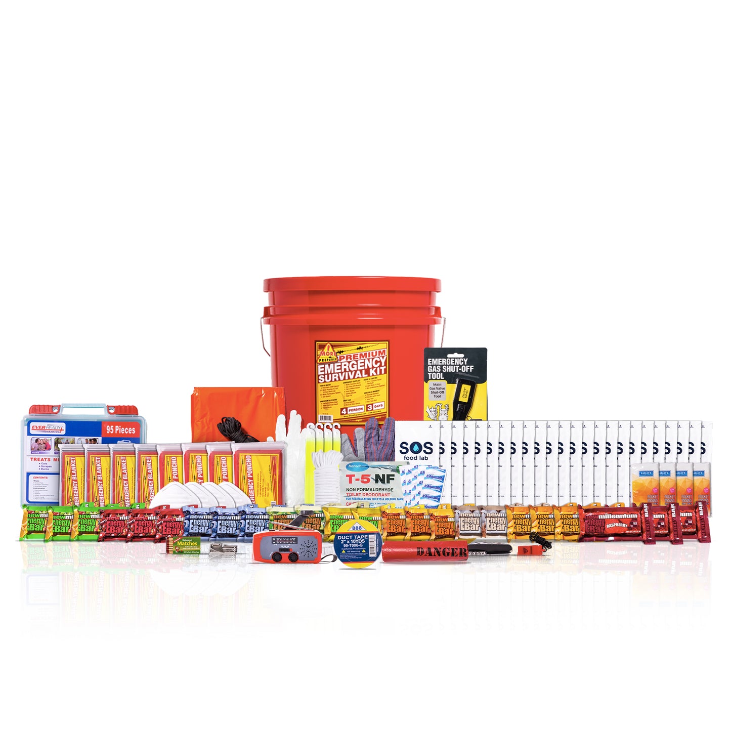 A comprehensive emergency survival kit arranged on a white reflective surface. The kit includes a large red bucket, an orange first-aid box, a blue and white battery, various yellow and orange food bars, water bottles, first-aid supplies, and other survival gear.