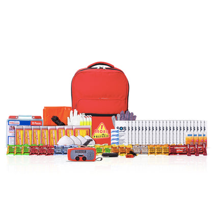 A comprehensive emergency preparedness and survival kit arranged neatly on a white background. The kit includes a bright red backpack, an orange emergency blanket, a red emergency whistle, a blue and orange personal locator beacon, multiple packs of instant noodles, bottled water, vitamins, first aid supplies, and other survival gear.